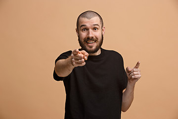 Image showing The happy business man point you and want you, half length closeup portrait on pastel background.