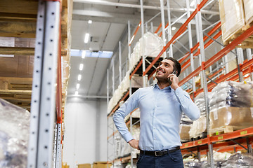 Image showing businessman calling on smartphone at warehouse