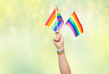 Image showing hand with gay pride rainbow flags and wristband