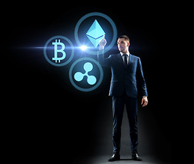 Image showing buisnessman with cryptocurrency holograms