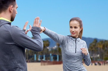 Image showing happy woman with coach working on strike outdoors