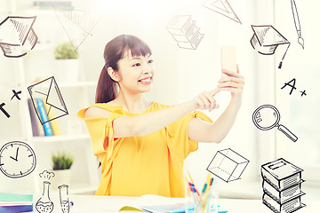 Image showing asian woman student taking selfie with smartphone