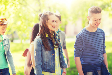 Image showing group of happy teenage students walking outdoors