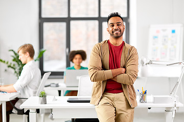 Image showing smiling indian man at office