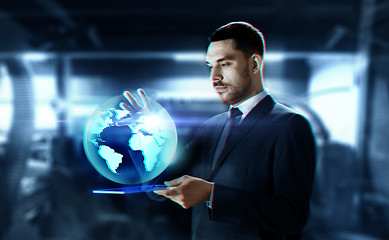 Image showing businessman with transparent tablet and earth