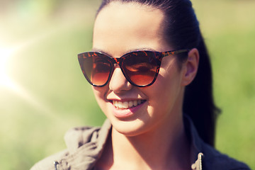 Image showing face of happy young woman in sunglasses outdoors