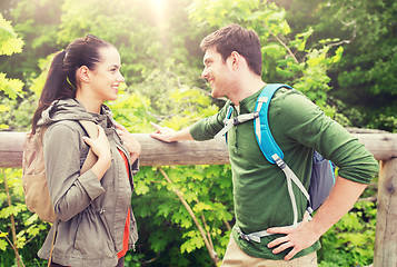 Image showing smiling couple with backpacks in nature