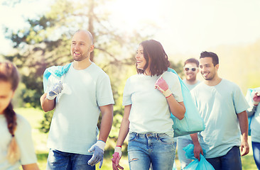 Image showing group of volunteers with garbage bags in park