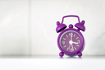 Image showing Purple alarm clock in a bright room