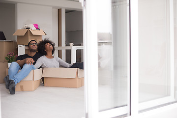 Image showing African American couple  playing with packing material