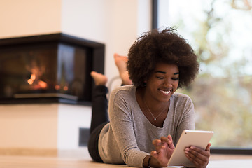 Image showing black women using tablet computer on the floor