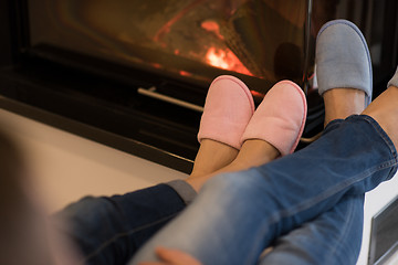 Image showing Young couple  in front of fireplace