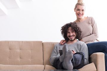 Image showing couple relaxing at  home with tablet computers