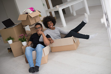 Image showing African American couple  playing with packing material