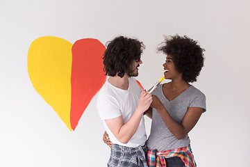 Image showing couple with painted heart on wall