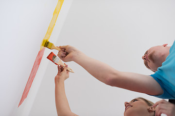 Image showing couple painting interior wall