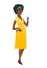 Image showing Pregnant woman holding a glass of water and pills.