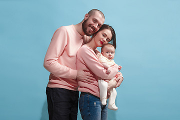 Image showing Happy family on the blue studio background