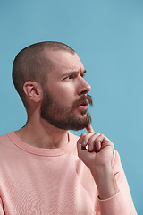 Image showing Young serious thoughtful businessman. Doubt concept.