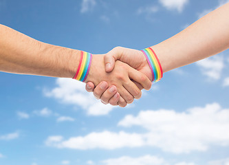 Image showing hands with gay pride wristbands make handshake