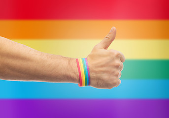 Image showing hand with gay pride rainbow wristband shows thumb