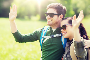 Image showing happy couple with backpacks hiking outdoors