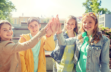 Image showing happy students or friends making high five