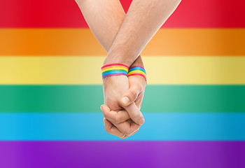 Image showing hands of couple with gay pride rainbow wristbands