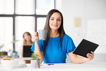 Image showing businesswoman with tablet pc and coffee at office