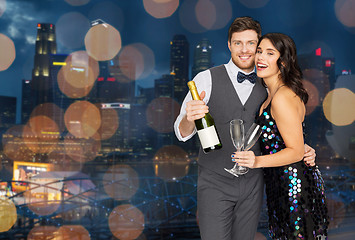 Image showing happy couple with champagne and glasses at party