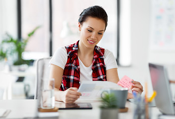 Image showing creative woman with papers working at office