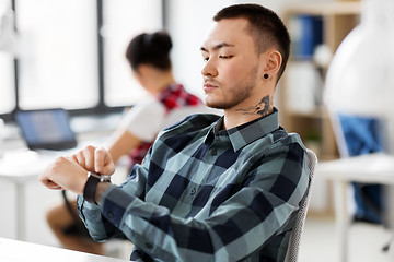 Image showing creative man with smart watch working at office