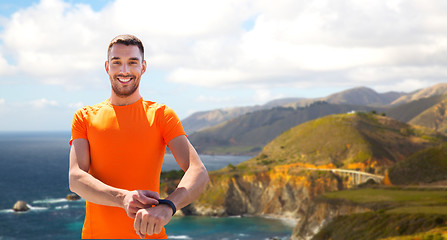 Image showing man with fitness tracker training outdoors