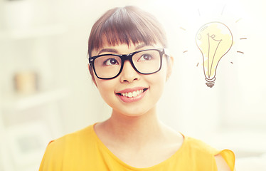 Image showing asian woman in glasses with light bulb doodle