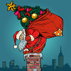 Image showing Santa Claus with a Christmas tree in a bag climbs the chimney