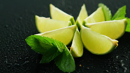 Image showing Lime segments with mint leaves