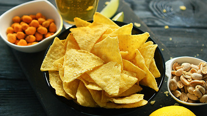 Image showing Plate of corn chips with nuts