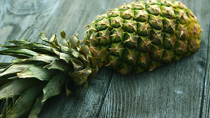 Image showing Half of pineapple on wooden table