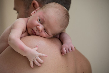 Image showing Father holding newborn baby son at the day time