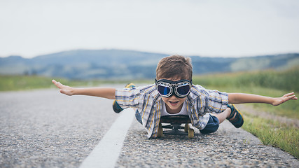 Image showing Happy little boy playing on the road at the day time. 