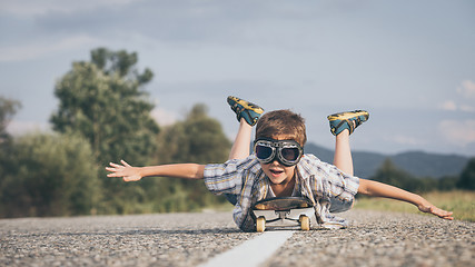 Image showing Happy little boy playing on the road at the day time.