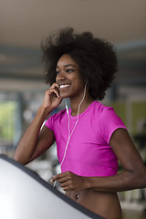 Image showing afro american woman running on a treadmill