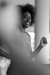 Image showing afro american woman running on a treadmill