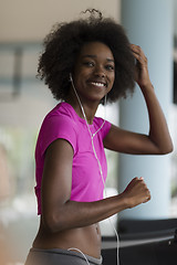 Image showing afro american woman running on a treadmill