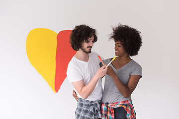 Image showing couple with painted heart on wall