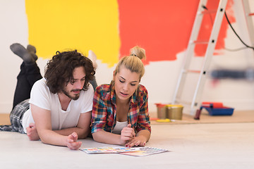 Image showing Happy young couple relaxing after painting