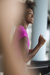 Image showing afro american woman running on a treadmill