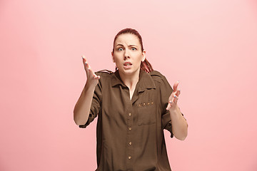 Image showing Beautiful woman looking suprised and bewildered isolated on pink