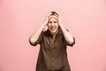 Image showing Beautiful woman looking suprised and bewildered isolated on pink