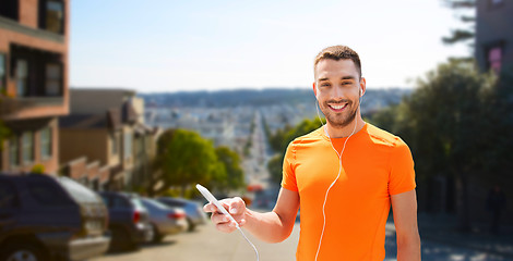 Image showing man with smartphone and earphones in san francisco